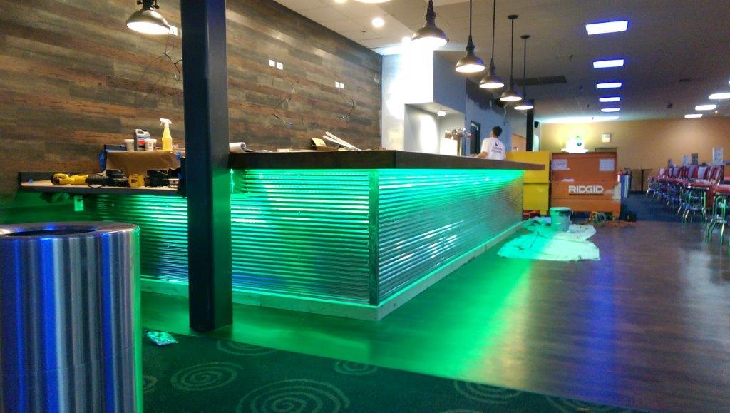 Galvanized Corrugated Panel Bar Wall, lit up with lights under the bar.